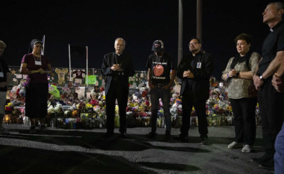 Bishop Mark J. Seitz and Father Fabian Marquez, both of El Paso, Texas, lead prayers Sept. 26, 2019, for Antonio Basco, who lost his wife, Margie Reckard, during the Aug. 3 Walmart mass shooting in El Paso.