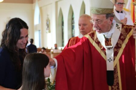 Archbishop Lori confirming a child
